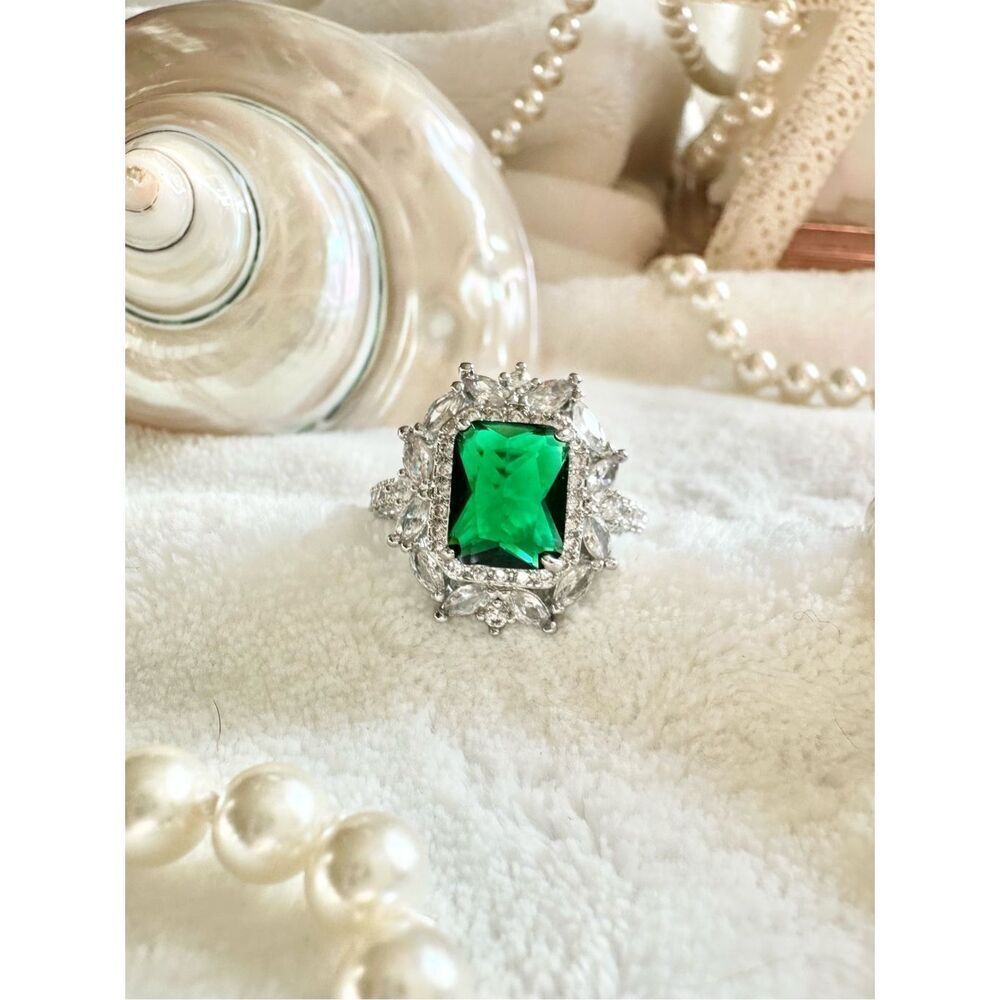 Emerald green elongated radiant cut cocktail ring